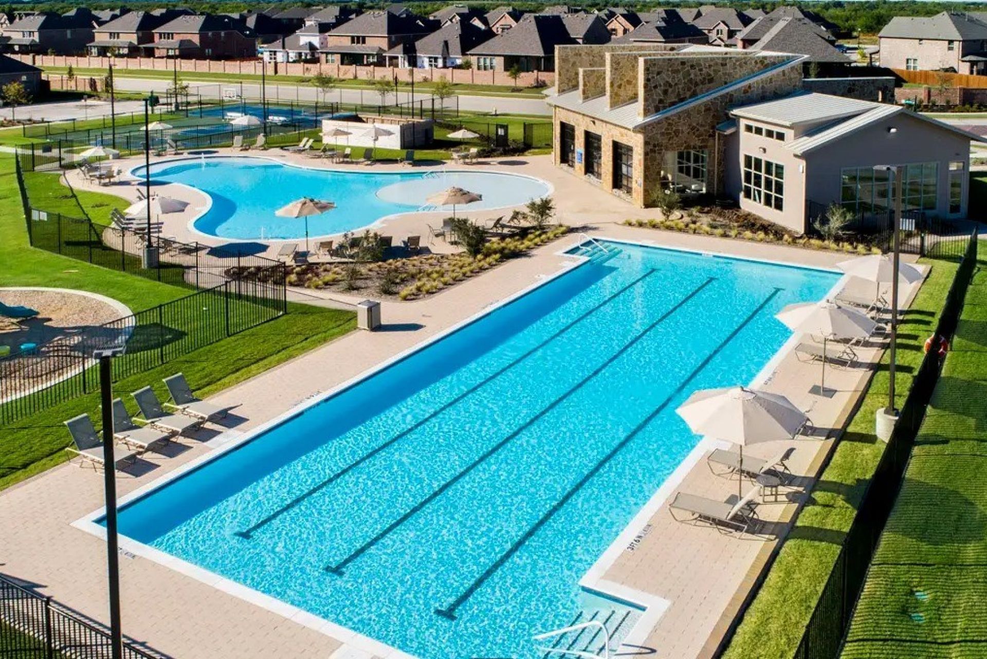 Elegant poolside setup with a modern patio, ideal for summer relaxation.
